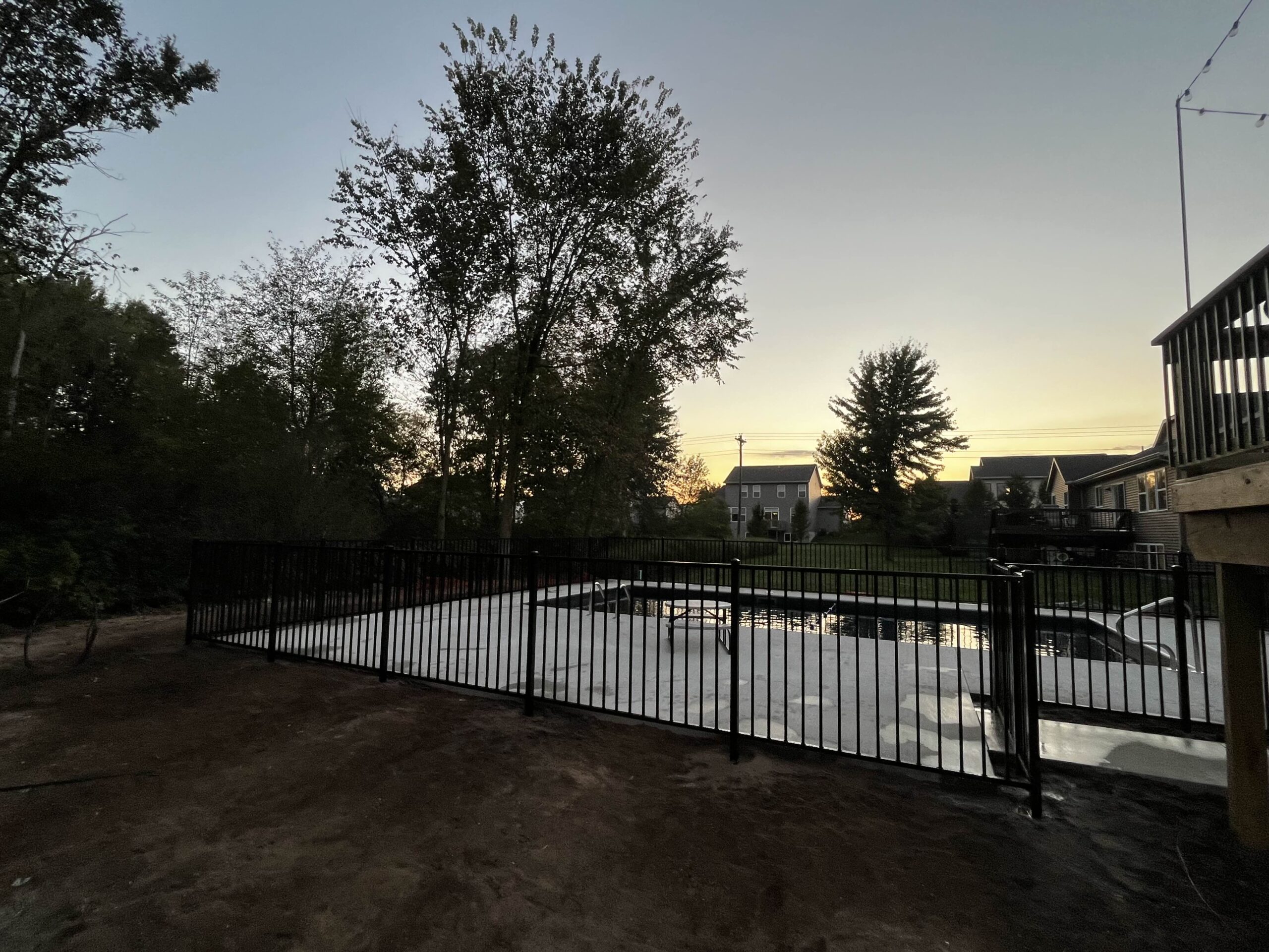 black aluminum pool fence install sunset